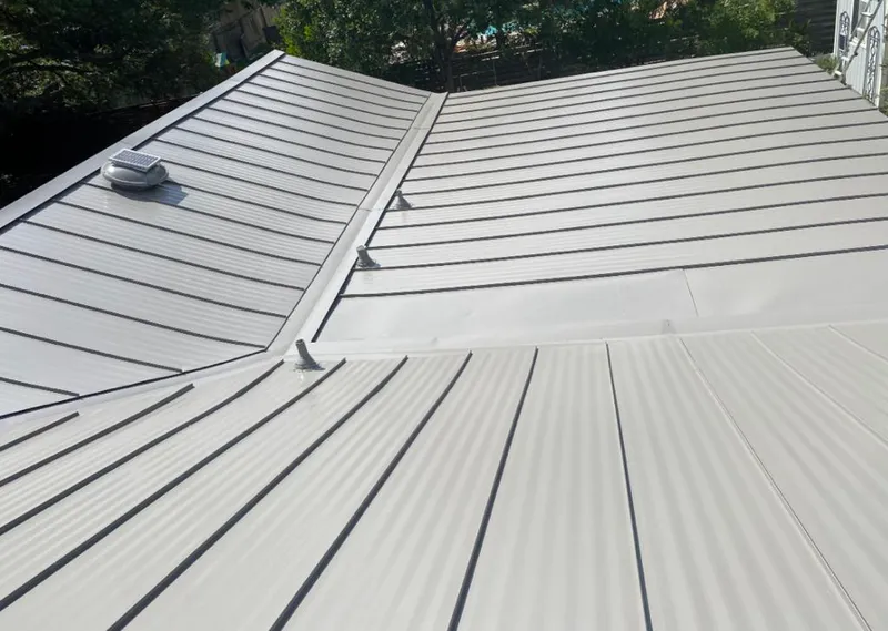 Solar attic fan installed on a metal roof for Roof Ventilation in Guymon